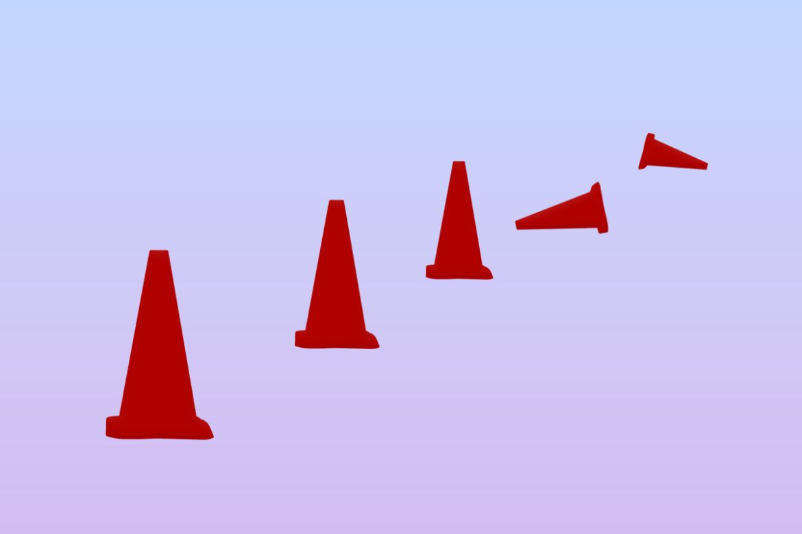 A line of cones. Some of which are knocked over.