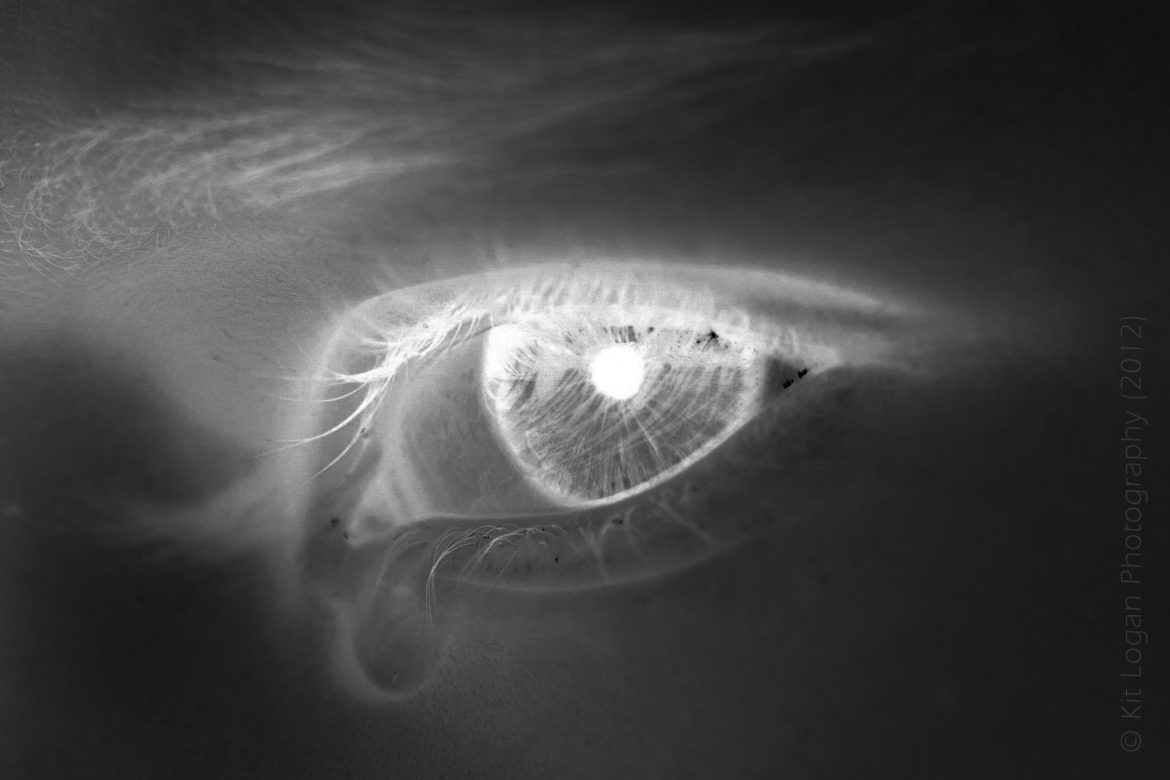 Copyright Kit Logan: Stylised moody black monochrome close up of a tearful eye.