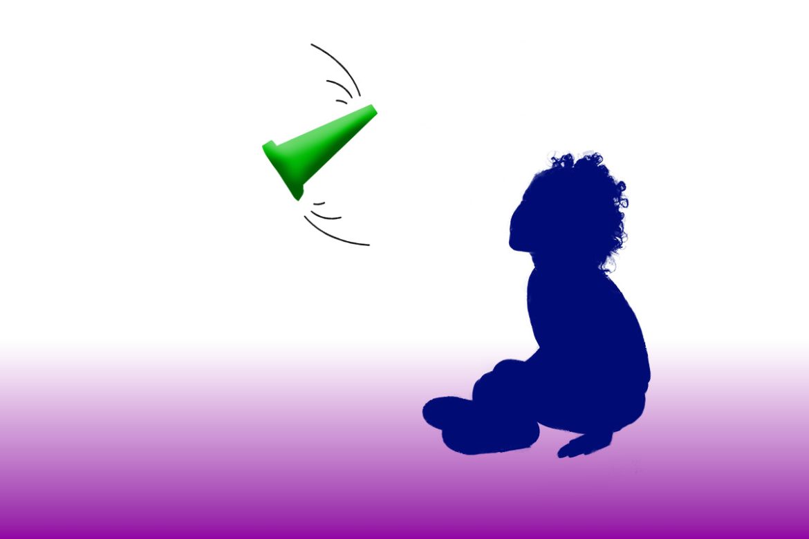 Seated child watching a cone flipping in the air.